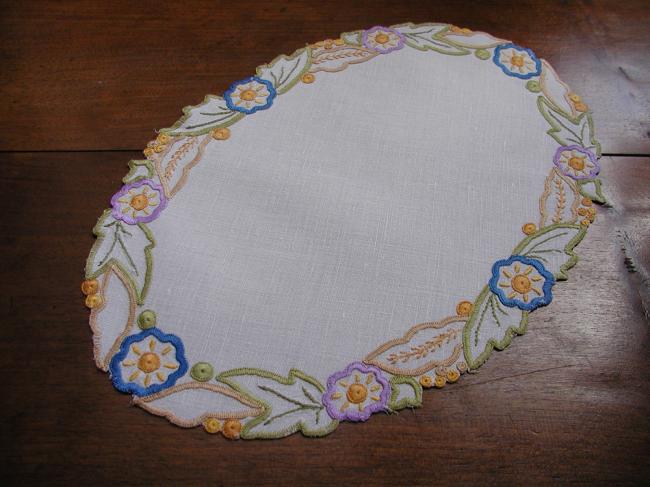 Such a pretty oval doily with colorful embroidery