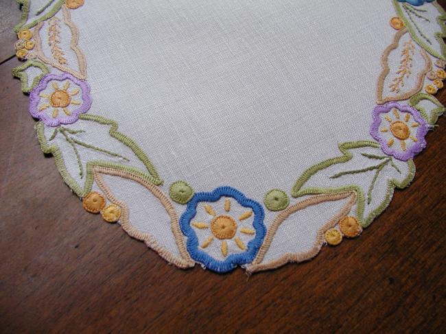 Such a pretty oval doily with colorful embroidery