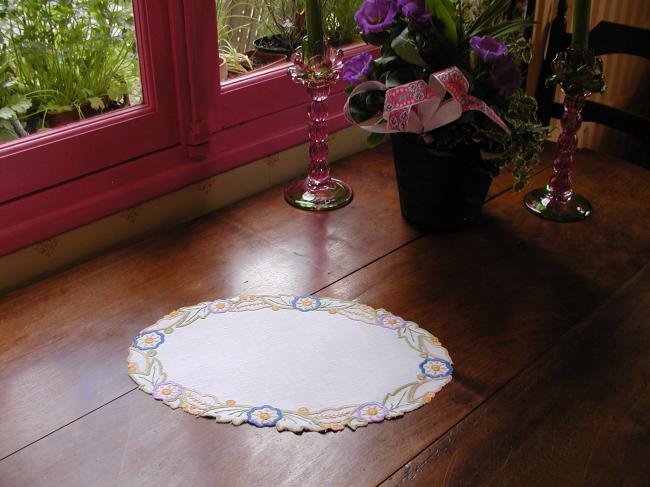 Such a pretty oval doily with colorful embroidery