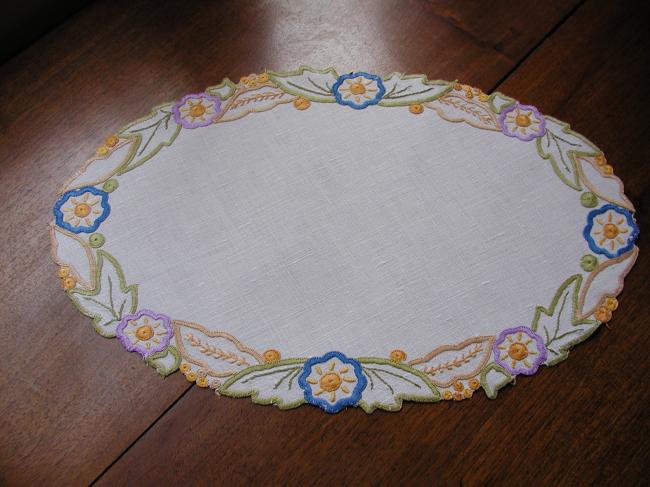 Such a pretty oval doily with colorful embroidery