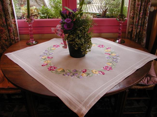 Very attractive tablecloth with a lovely hand made embroidered crown of flowers