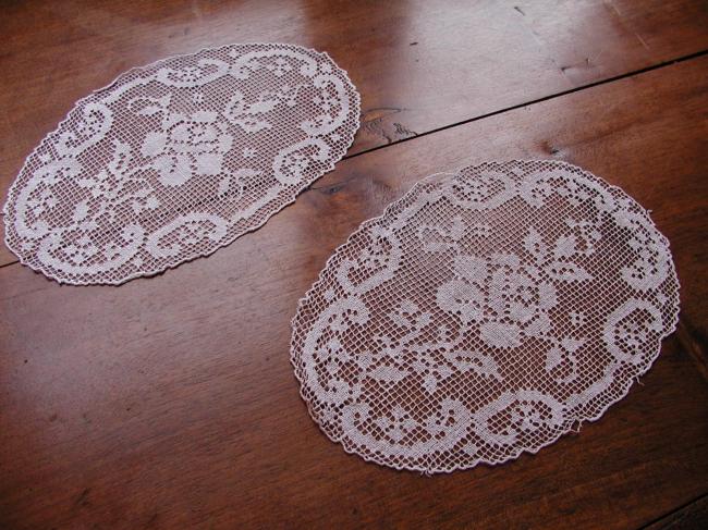 Gracious pair of hand made oval filet lace doilies depicting roses