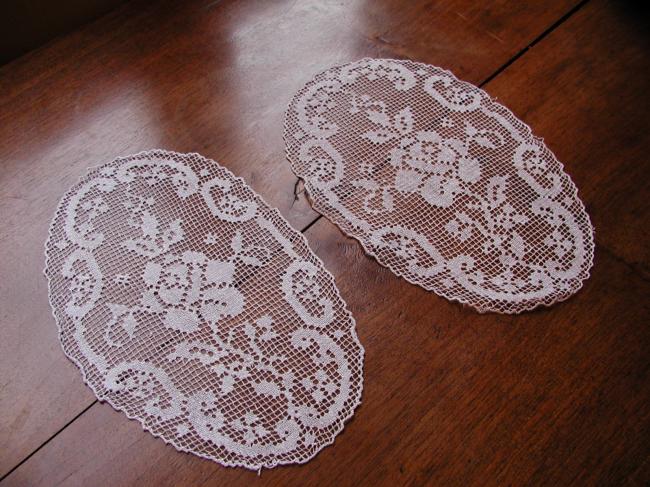 Gracious pair of hand made oval filet lace doilies depicting roses