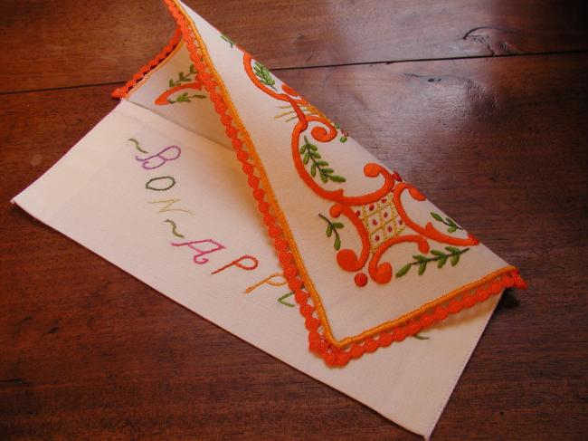 Lovely napkin case with hand-embroidered volutes and orange flowers