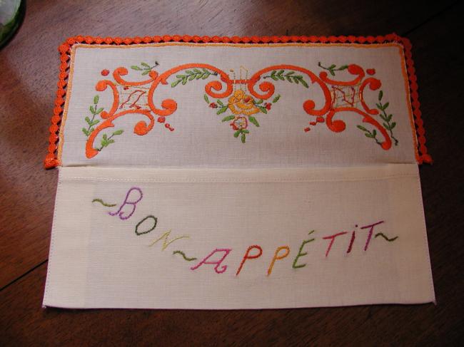 Lovely napkin case with hand-embroidered volutes and orange flowers