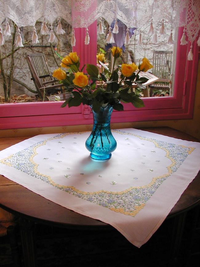 Striking tablecloth with hand-embroidered spring flowers