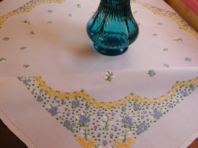 Striking tablecloth with hand-embroidered spring flowers