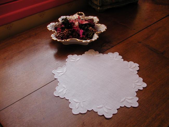 So charming round doily with scalopped edging and embroidered foliage