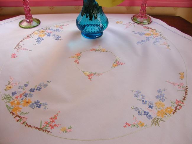 Really romantic tablecloth with embroidered summer flowers in a garden