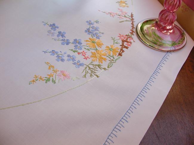 Really romantic tablecloth with embroidered summer flowers in a garden