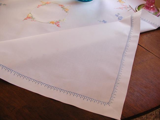 Really romantic tablecloth with embroidered summer flowers in a garden