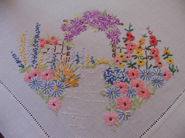 Striking tablecloth with hand-embroidered bower of summer flowers