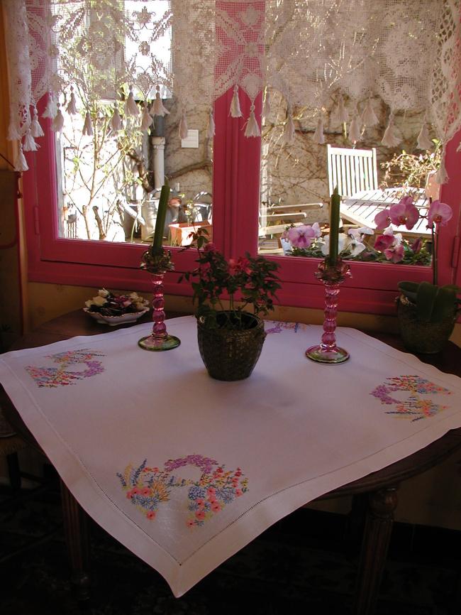 Striking tablecloth with hand-embroidered bower of summer flowers