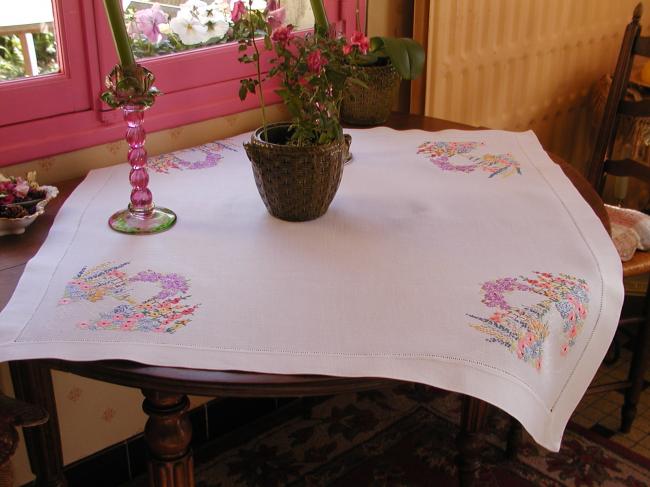 Striking tablecloth with hand-embroidered bower of summer flowers