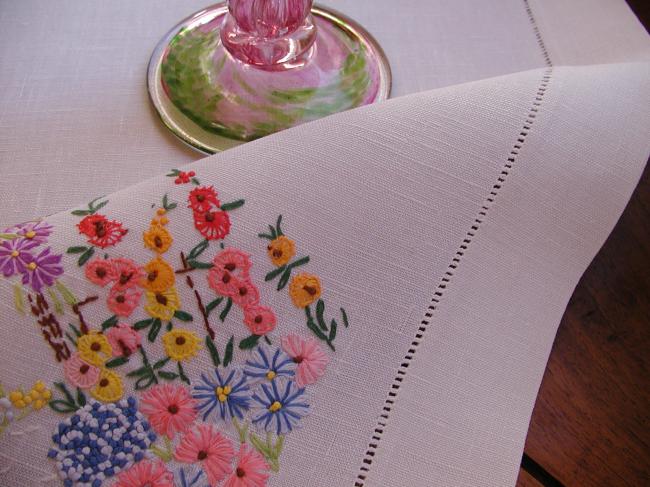 Striking tablecloth with hand-embroidered bower of summer flowers