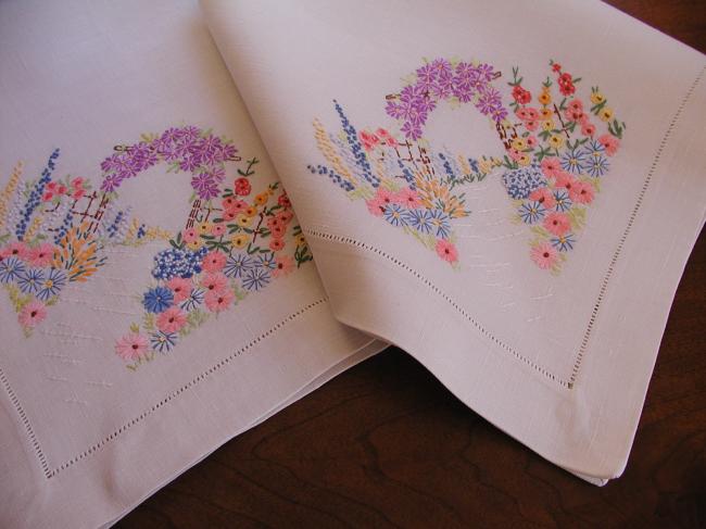 Striking tablecloth with hand-embroidered bower of summer flowers