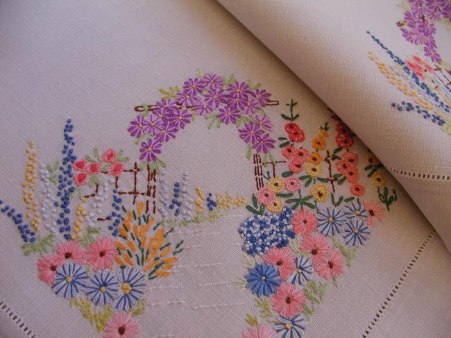 Striking tablecloth with hand-embroidered bower of summer flowers