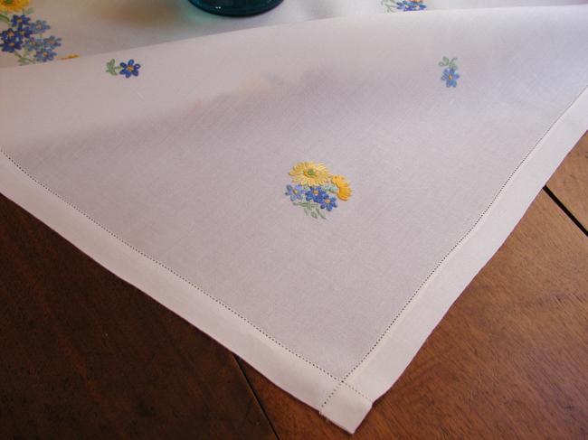 Lovely tablecloth with hand-embroidered crown of yellow and blue flowers