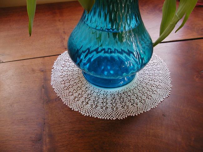 Sweet round doily with very fine crochet lace