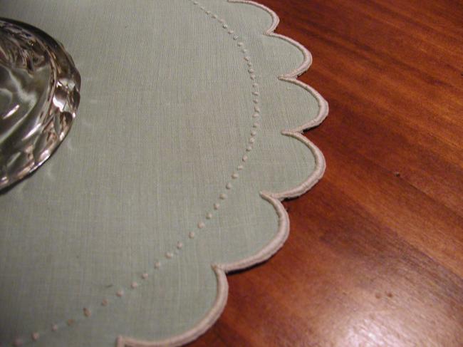 Charming round doily in pale green color