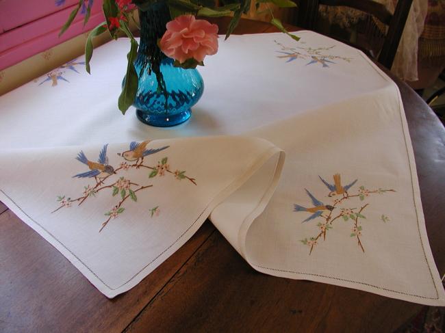 Very pretty tablecloth with birds in a blooming apple-tree