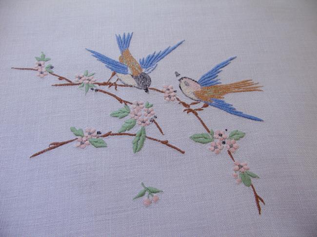 Very pretty tablecloth with birds in a blooming apple-tree