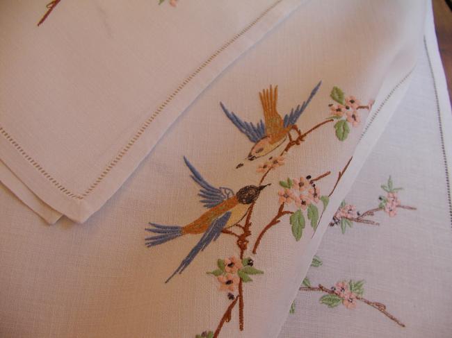 Very pretty tablecloth with birds in a blooming apple-tree