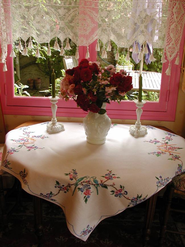 So sweet tablecloth with hand-embroidered parakeets in blooming tree