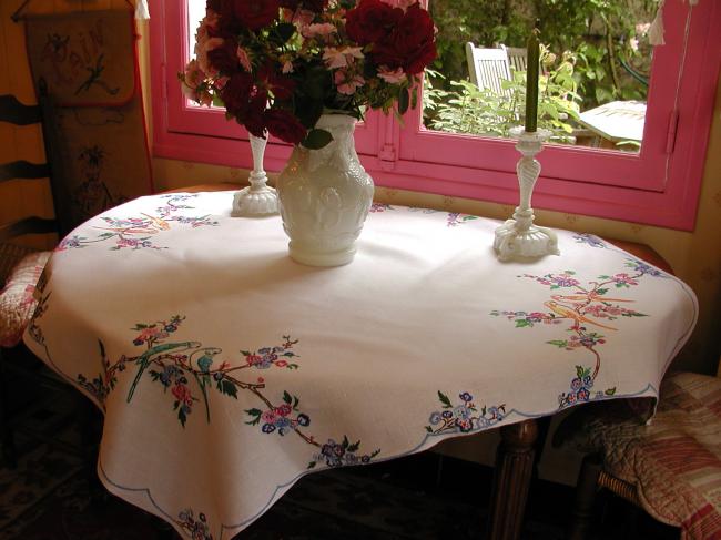 So sweet tablecloth with hand-embroidered parakeets in blooming tree