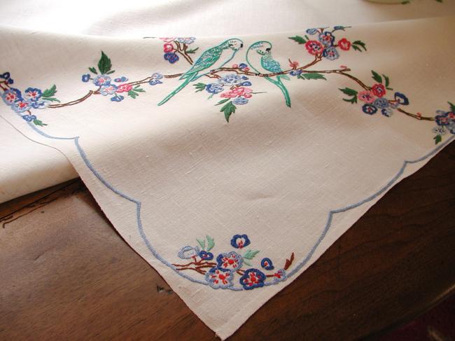 So sweet tablecloth with hand-embroidered parakeets in blooming tree