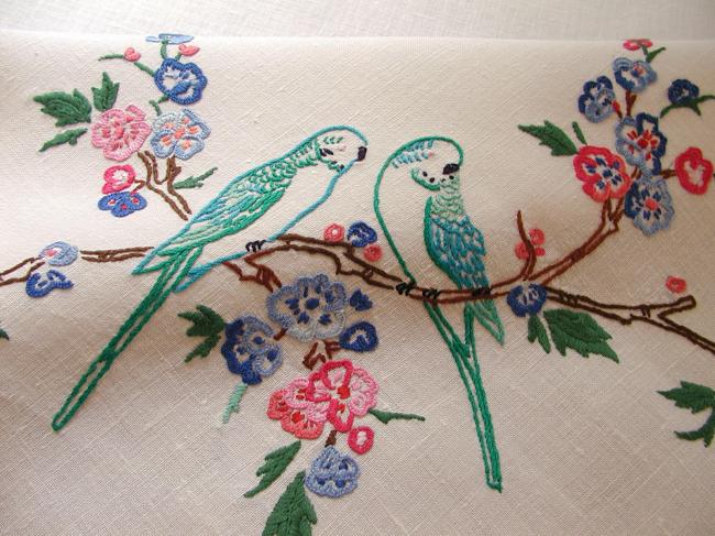 So sweet tablecloth with hand-embroidered parakeets in blooming tree