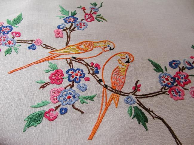 So sweet tablecloth with hand-embroidered parakeets in blooming tree