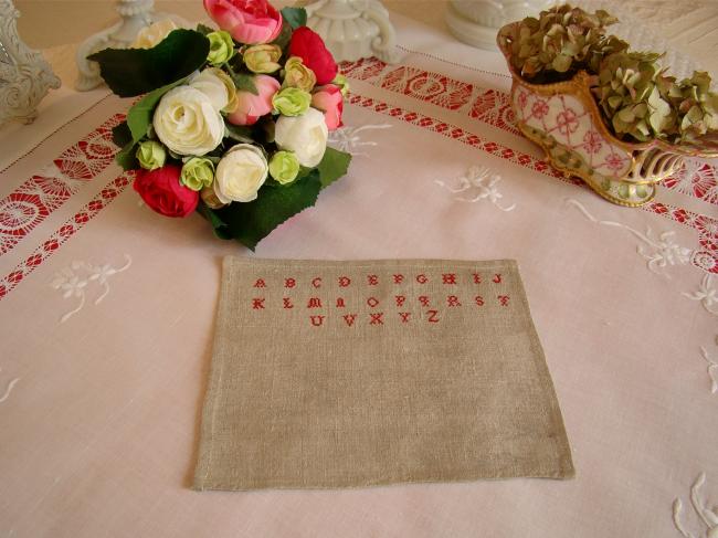 Tiny sampler made in red cross stitches on hemp, circa 1900