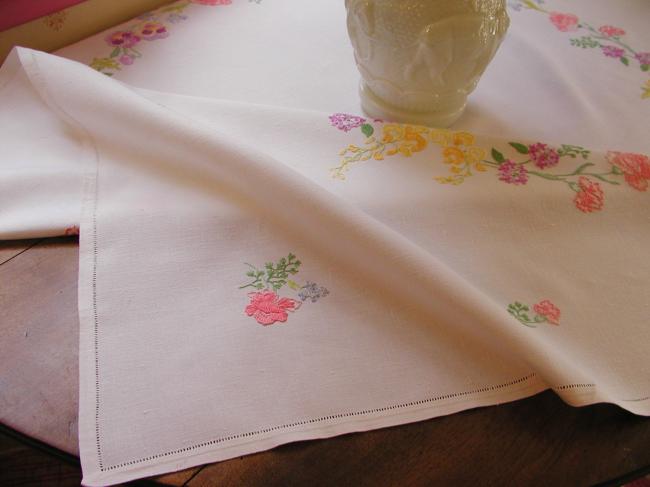 Breathtaking tablecloth with hand-embroidered garland of spring flowers