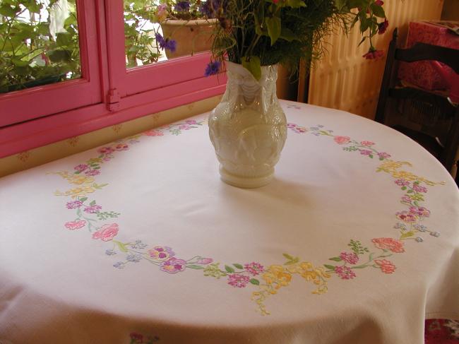 Breathtaking tablecloth with hand-embroidered garland of spring flowers