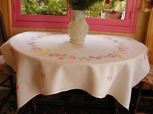 Breathtaking tablecloth with hand-embroidered garland of spring flowers