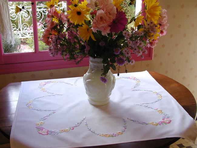 Really romantic tablecloth with embroidered summer flowers in a garden