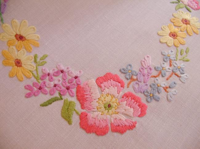 Really romantic tablecloth with embroidered summer flowers in a garden