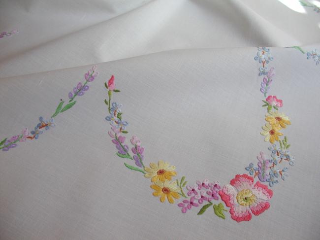 Really romantic tablecloth with embroidered summer flowers in a garden