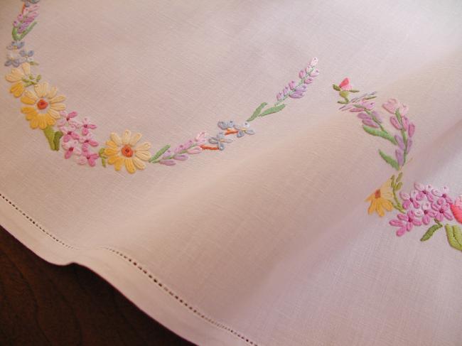 Really romantic tablecloth with embroidered summer flowers in a garden