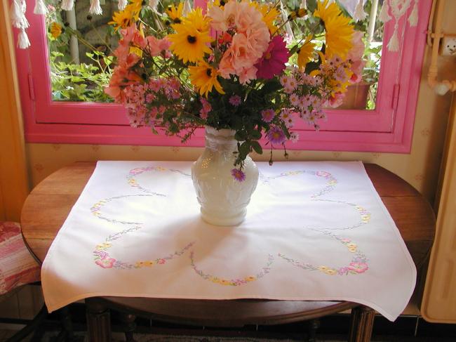 Really romantic tablecloth with embroidered summer flowers in a garden