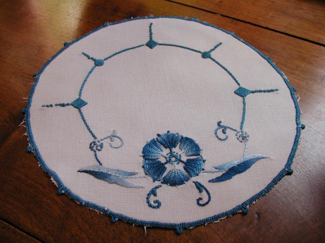 Such a pretty oval doily with blue embroidery