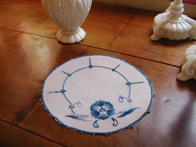 Such a pretty oval doily with blue embroidery