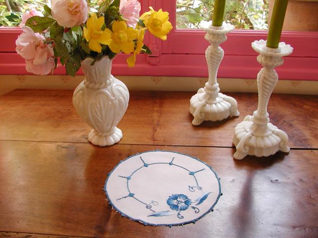 Such a pretty oval doily with blue embroidery