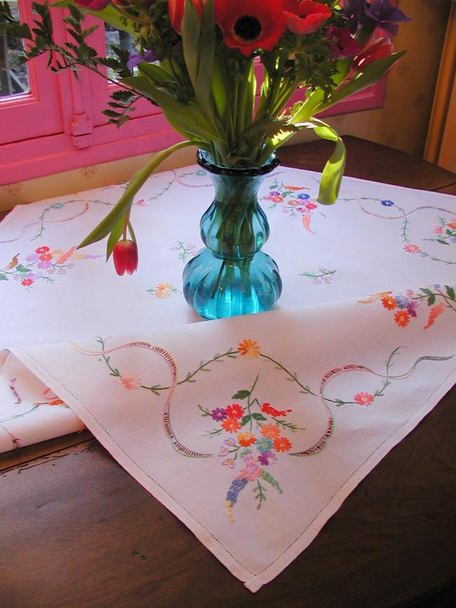 Really adorable tablecloth with hand-embroidered wild bouquets and ribbons