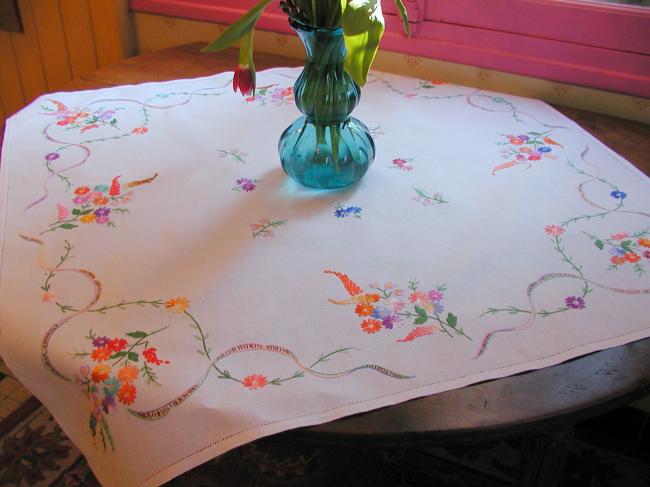 Really adorable tablecloth with hand-embroidered wild bouquets and ribbons