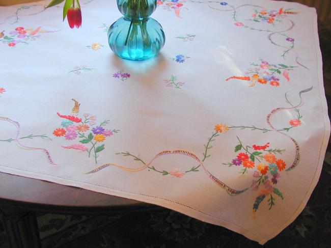 Really adorable tablecloth with hand-embroidered wild bouquets and ribbons