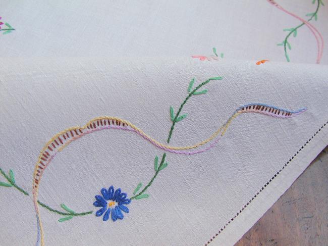 Really adorable tablecloth with hand-embroidered wild bouquets and ribbons