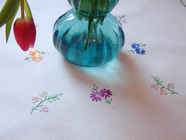 Really adorable tablecloth with hand-embroidered wild bouquets and ribbons