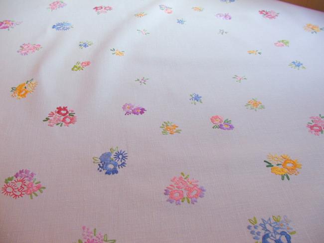 Really adorable tablecloth with hand-embroidered tiny bouquets and garland